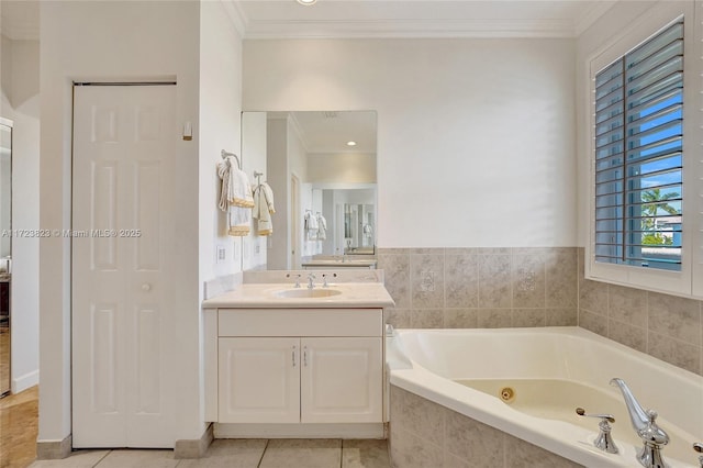 bathroom featuring tile patterned floors, tiled bath, crown molding, and vanity