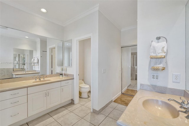 bathroom with tile patterned floors, toilet, vanity, and ornamental molding