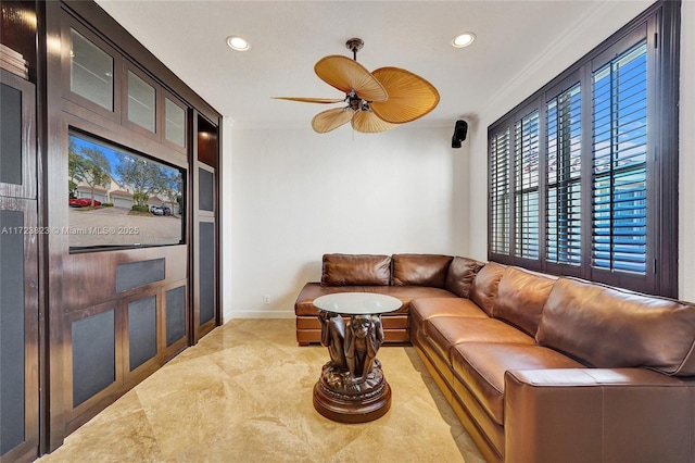 living room with ceiling fan and crown molding