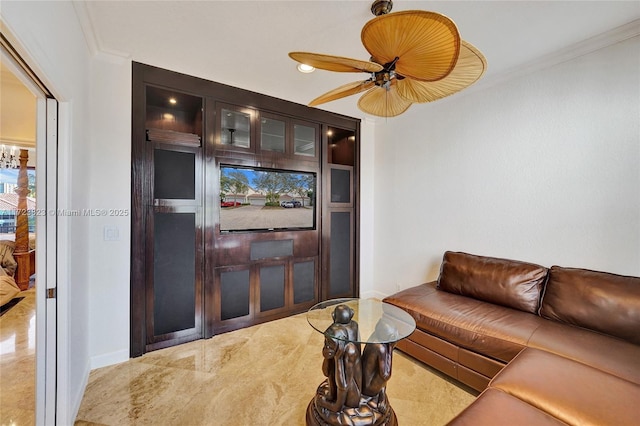 living room featuring crown molding and ceiling fan