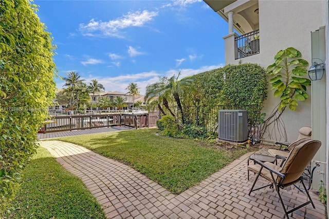 view of yard with a balcony and central AC