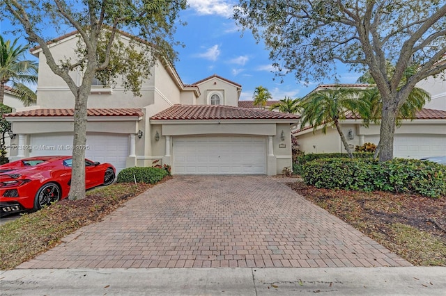 mediterranean / spanish-style house with a garage