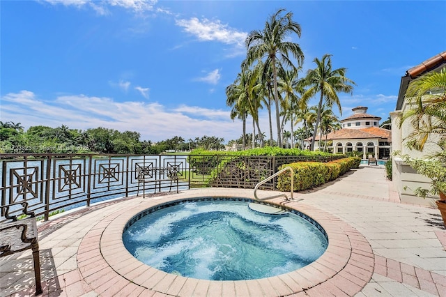 view of swimming pool with an in ground hot tub and a patio area