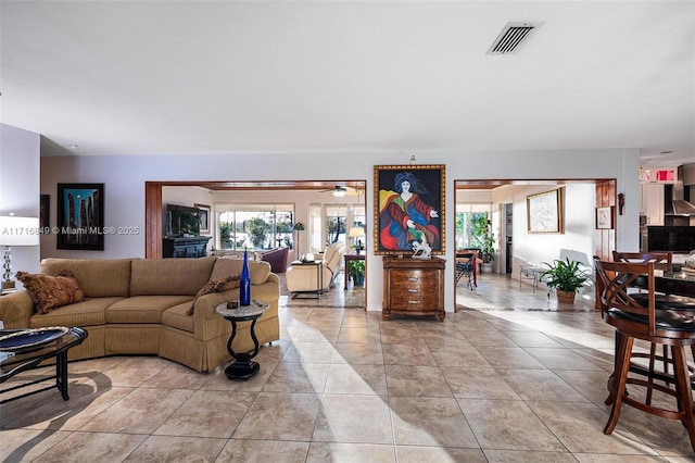 tiled living room with ceiling fan