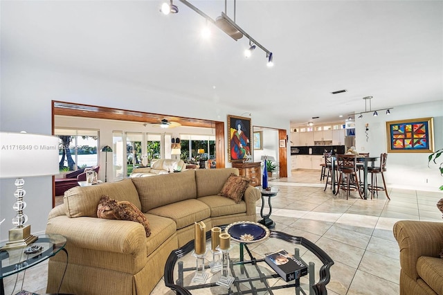 living room with ceiling fan and light tile patterned floors