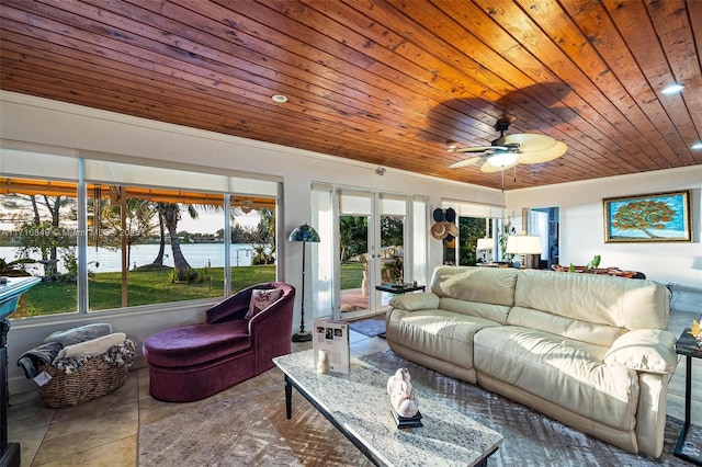 sunroom / solarium featuring french doors, a water view, a wealth of natural light, and wooden ceiling