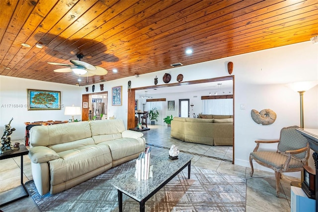 tiled living room with ceiling fan and wood ceiling