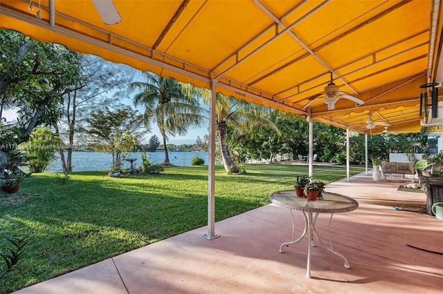 view of patio featuring ceiling fan and a water view