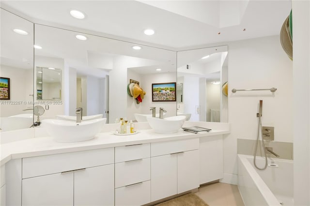 bathroom featuring a washtub and vanity