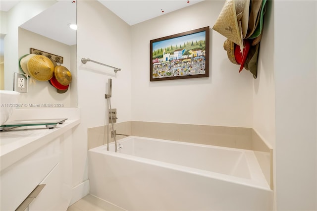 bathroom with a washtub and vanity