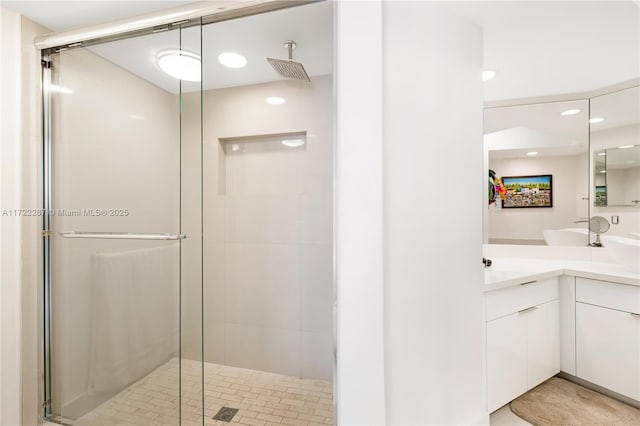 bathroom featuring vanity and an enclosed shower