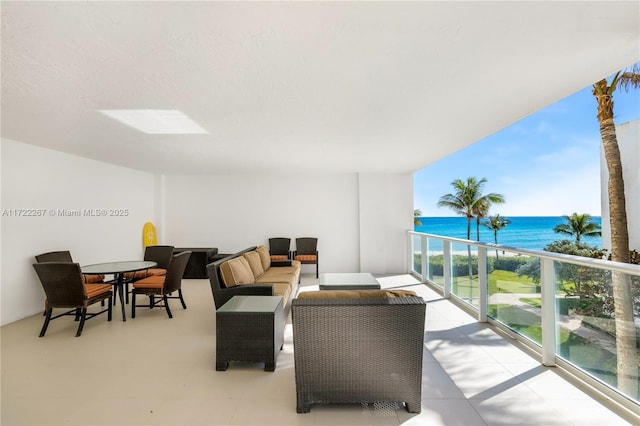 balcony with an outdoor hangout area and a water view