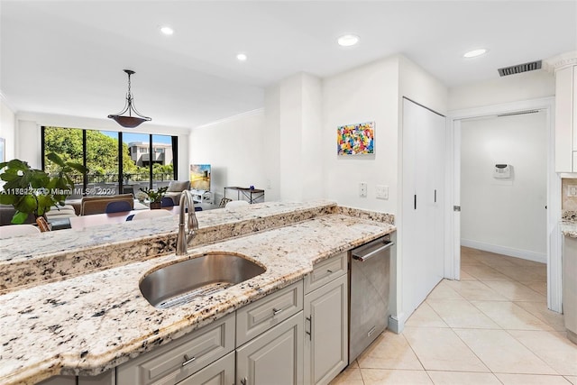 kitchen featuring stainless steel dishwasher, pendant lighting, light stone countertops, and sink