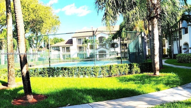 view of home's community with a yard