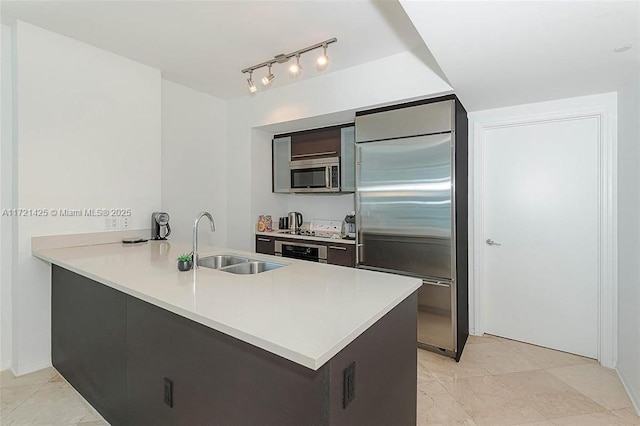 55 SE 6th St Unit 1507, Miami, FL 33131 - kitchen with stainless steel appliances, a sink, a peninsula, and light countertops
