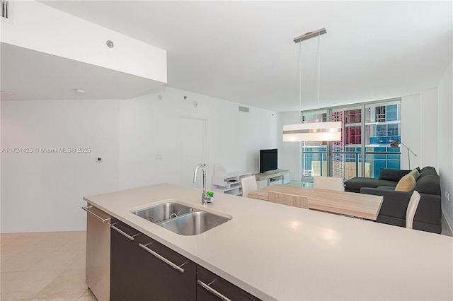 55 SE 6th St Unit 1507, Miami, FL 33131 - kitchen with a sink, open floor plan, light countertops, hanging light fixtures, and floor to ceiling windows