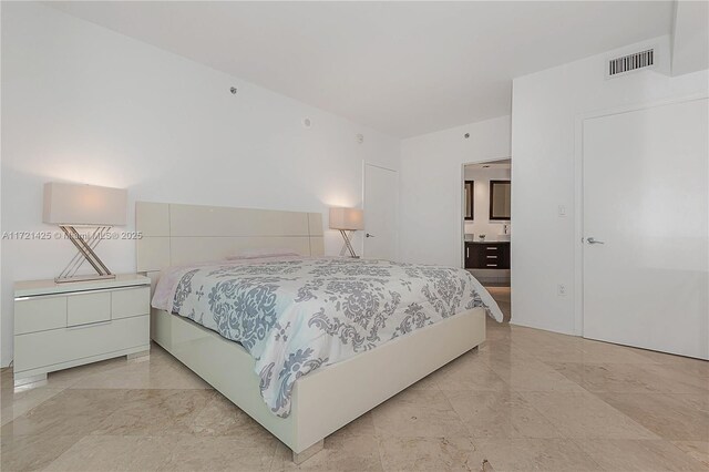 55 SE 6th St Unit 1507, Miami, FL 33131 - bedroom with light marble finish floors and connected bathroom