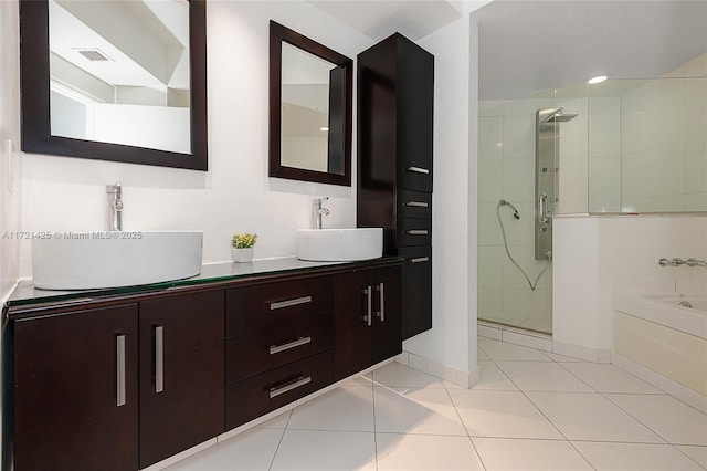 55 SE 6th St Unit 1507, Miami, FL 33131 - full bathroom featuring a stall shower, a garden tub, double vanity, tile patterned floors, and baseboards