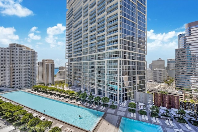 view of property featuring a community pool and a city view