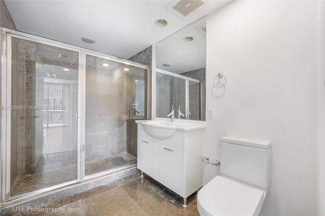 full bath with visible vents, a shower stall, toilet, and vanity