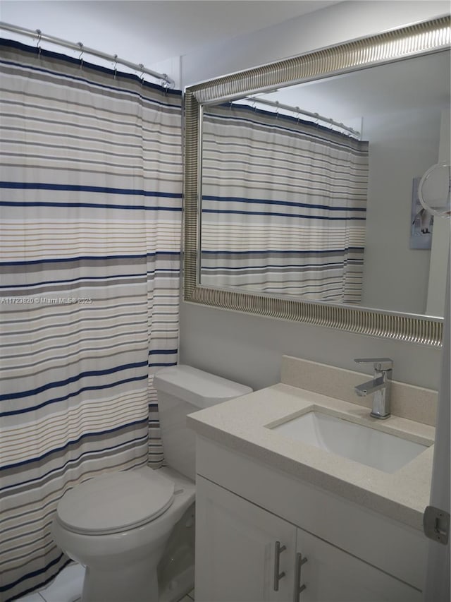 bathroom with vanity, toilet, and a shower with shower curtain