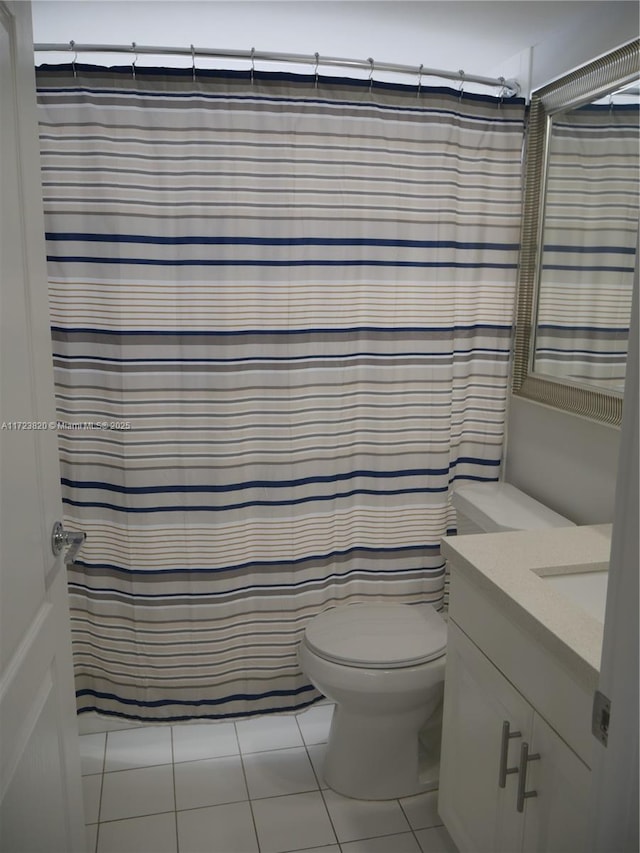 bathroom with vanity, tile patterned flooring, toilet, and a shower with shower curtain