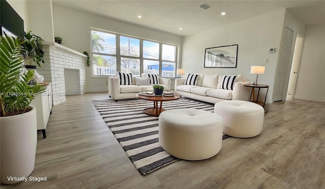 living room with a fireplace and light hardwood / wood-style floors