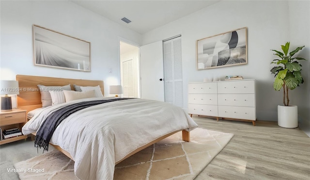 bedroom with hardwood / wood-style flooring and a closet