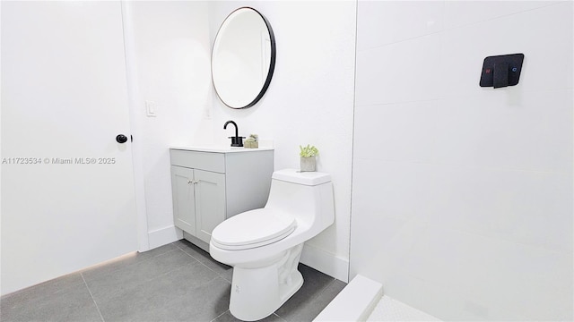 bathroom with vanity, tile patterned floors, and toilet