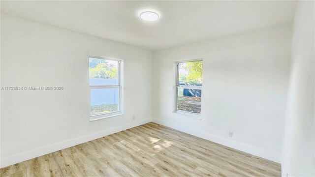 unfurnished room with plenty of natural light and light hardwood / wood-style floors