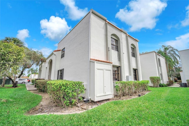 view of property exterior with a yard