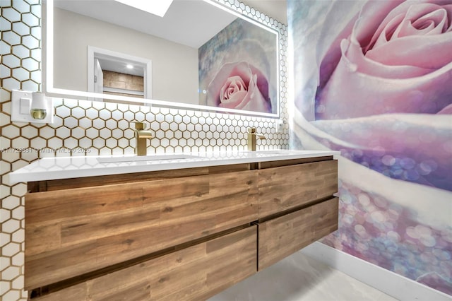 details with a skylight, tasteful backsplash, and vanity