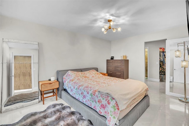 bedroom with a notable chandelier, a closet, and a spacious closet