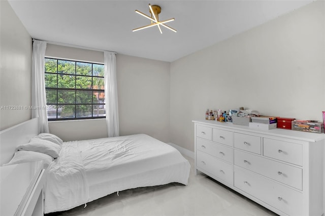 bedroom featuring a notable chandelier