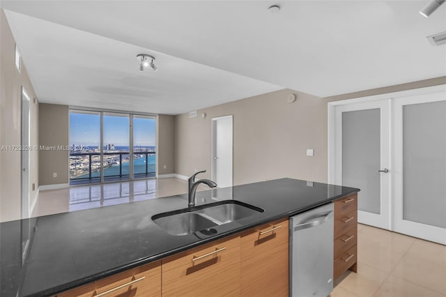 kitchen featuring floor to ceiling windows, french doors, sink, stainless steel dishwasher, and light tile patterned flooring