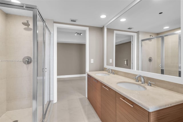 bathroom featuring tile patterned flooring, vanity, and walk in shower