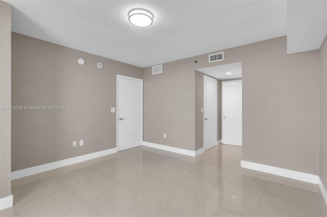 spare room featuring light tile patterned floors