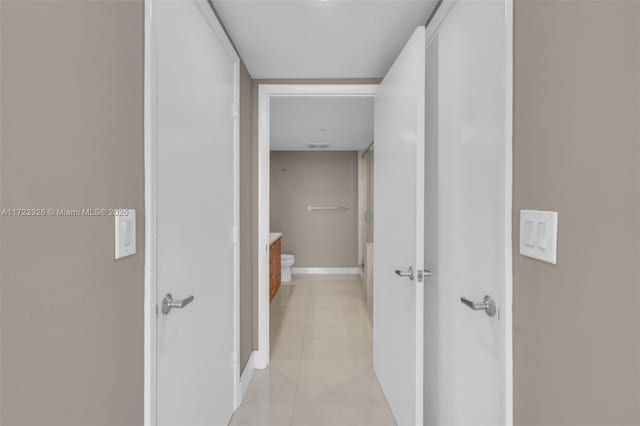 corridor featuring light tile patterned flooring