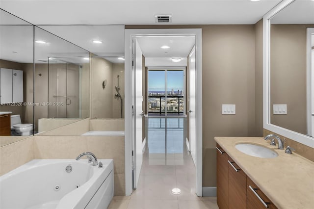 bathroom featuring tile patterned flooring, vanity, and plus walk in shower