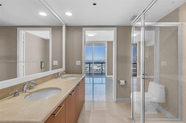 bathroom with walk in shower, tile patterned flooring, vanity, and toilet