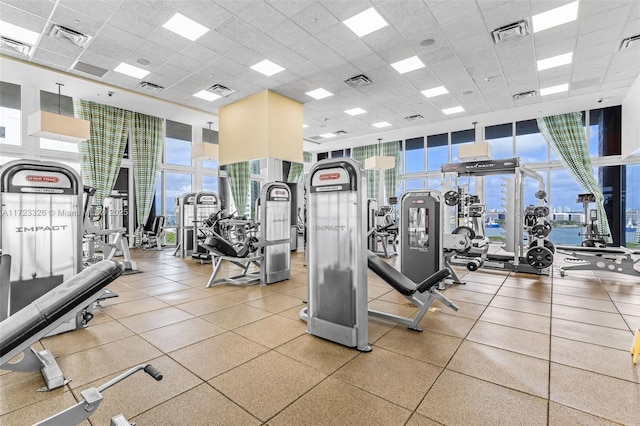 gym with a paneled ceiling