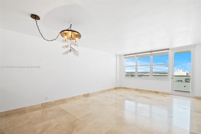 spare room with an inviting chandelier