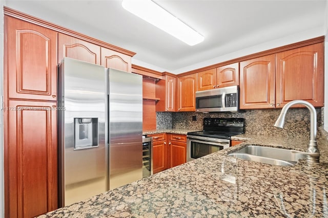 kitchen with stainless steel appliances, tasteful backsplash, light stone countertops, and sink