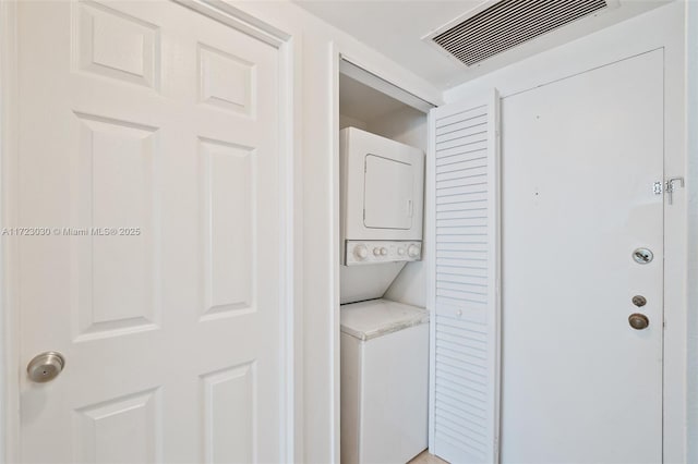 laundry room with stacked washer / dryer