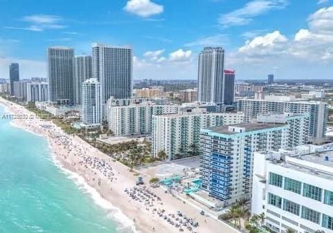 bird's eye view with a view of the beach and a water view