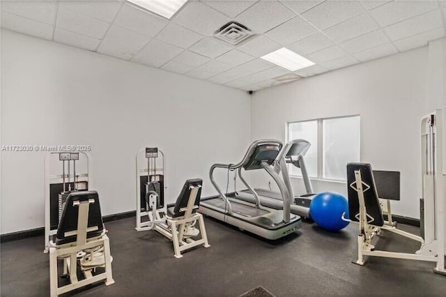 exercise room with a drop ceiling