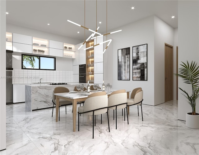 dining room with sink and a chandelier