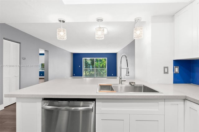 kitchen with dishwasher, white cabinets, sink, hanging light fixtures, and kitchen peninsula