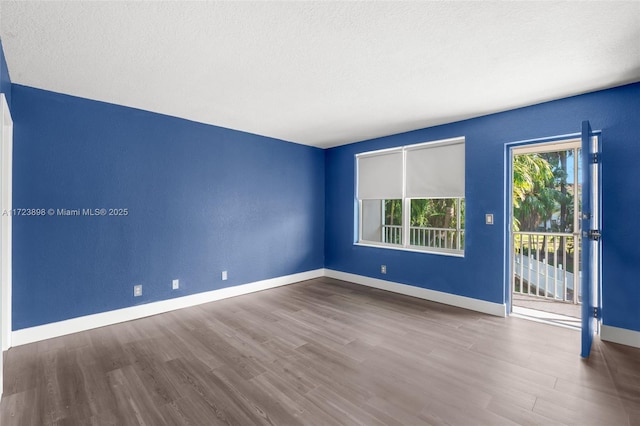 empty room with wood-type flooring