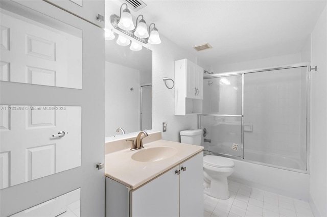 full bathroom with tile patterned flooring, vanity, toilet, and combined bath / shower with glass door